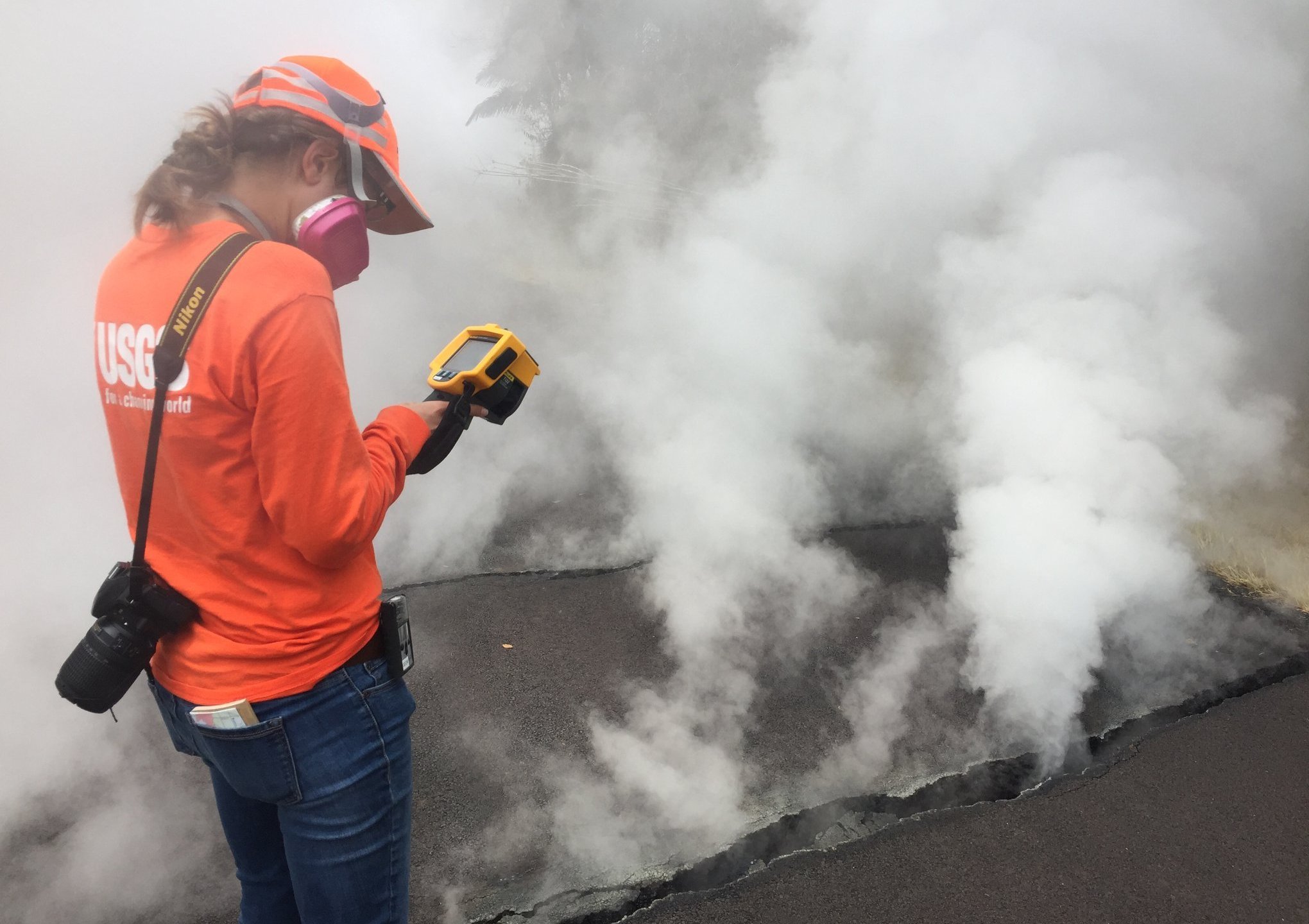 USGS-Hawaiian Volcano Observatory geologist measured a temperature of 103 degrees C (218 degree F) at a crack along Nohea Street, Leilani Estates. The asphalt road was describes as "mushy" from the heat. (Credit: USGS VOLCANOES)