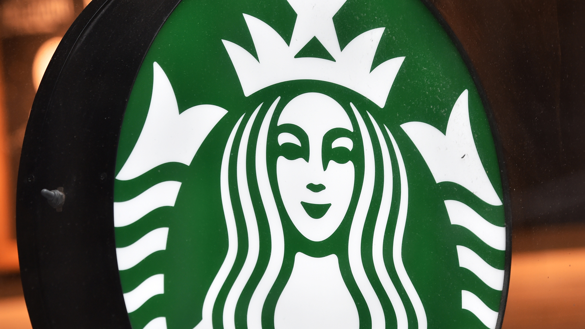 The Starbucks logo hangs outside one of the company's cafes in Northwich on 3 July, 2008 in Northwich, England. (Credit: Christopher Furlong/Getty Images)