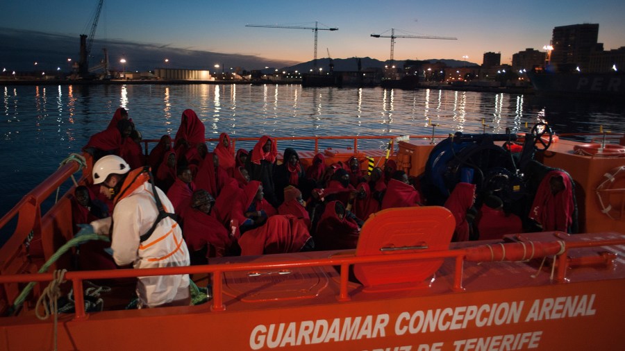 A group of migrants arrive on board a Spanish coast guard vessel at the southern Spanish port of Malaga on Jan. 13, 2018. (Credit: JORGE GUERRERO/AFP/Getty Images)