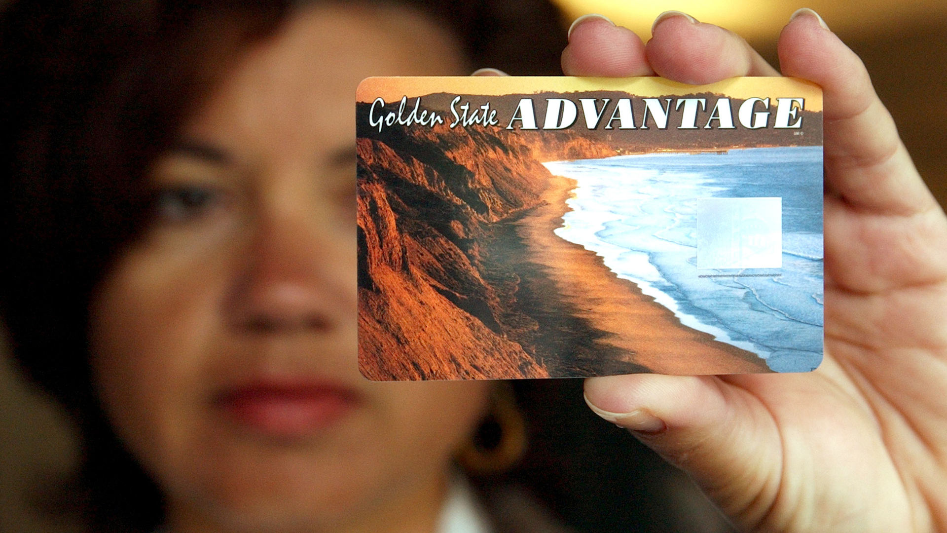 A woman holds a sample of the California State Electronic Benefit Transfer card on July 17, 2002, in Oakland, Calif. (Credit: Justin Sullivan/Getty Images)