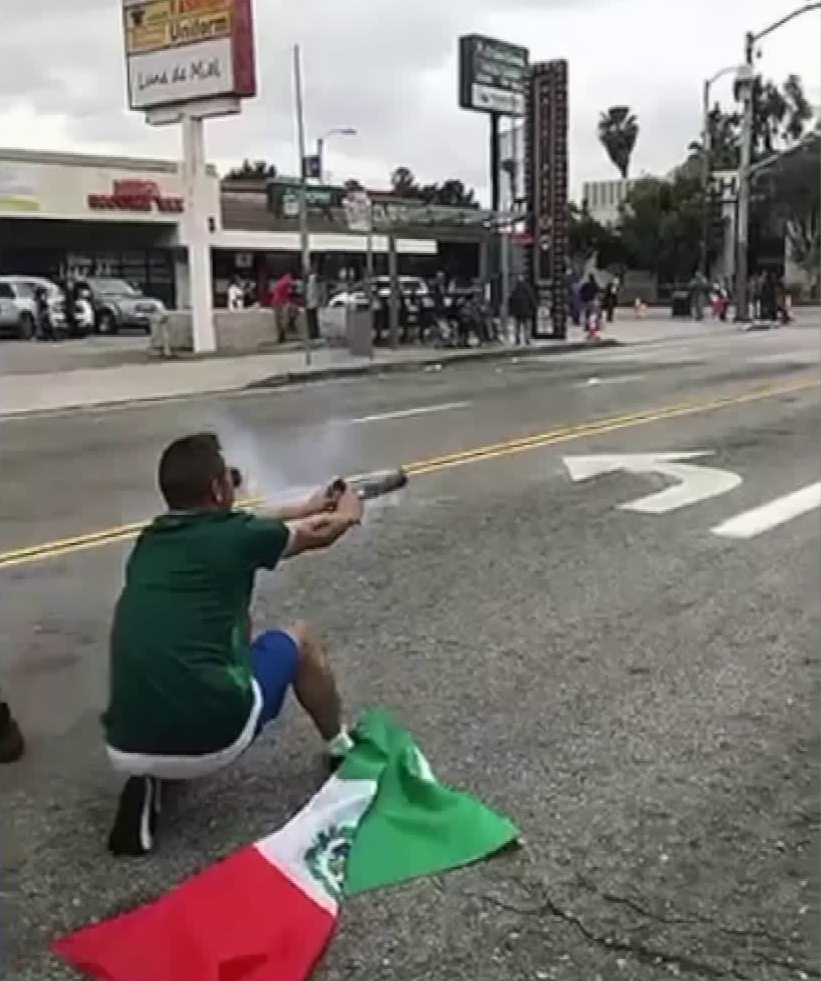 A man is shown on video from Eddie's Twitter account @Gvmbiit on June 17, 2018, launching a firework at Huntington Park Police Department officers.