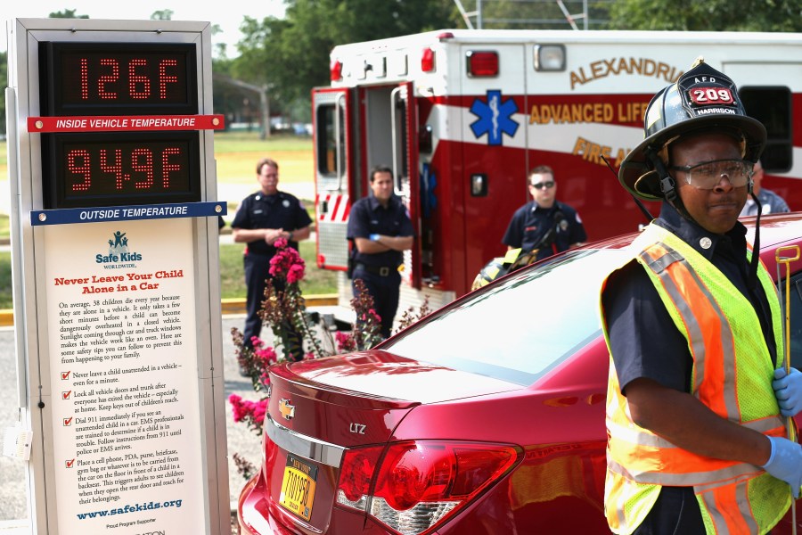 Fire and EMS officials participate in a demonstration of the dangers of leaving children unattended in vehicles during a news conference in Alexandria, Virginia. (Credit: Chip Somodevilla/Getty Images)