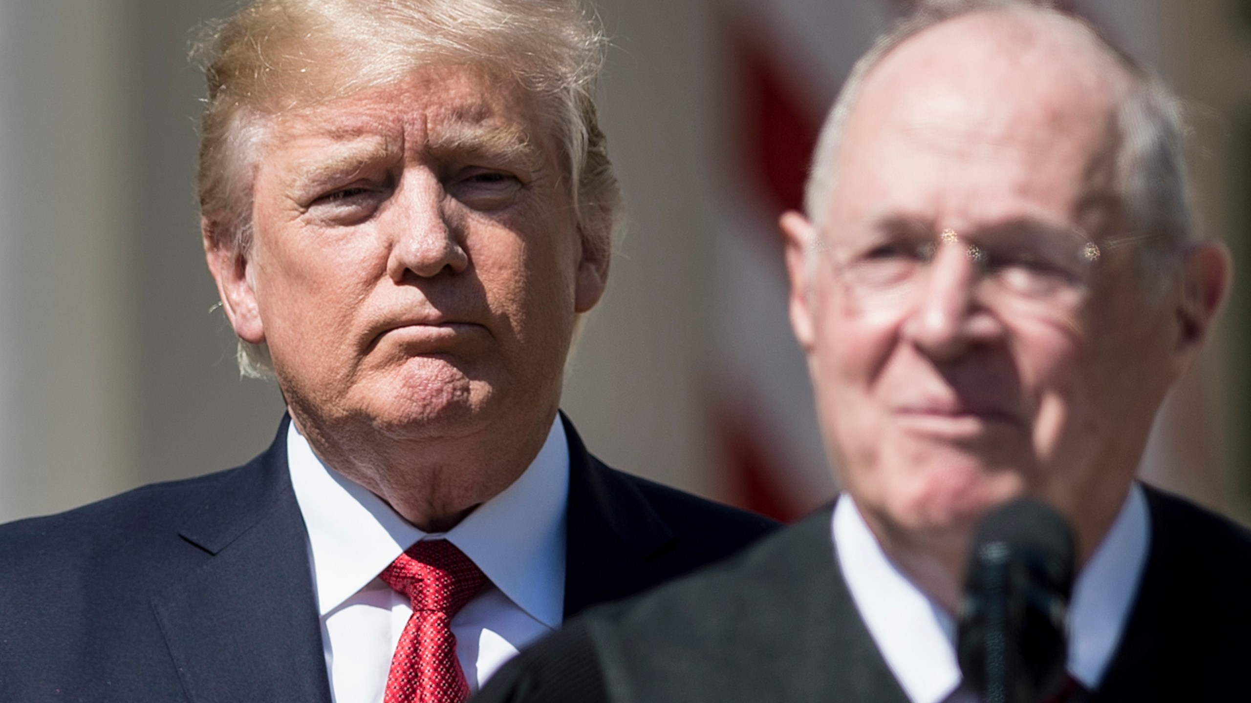 Donald Trump listens while Supreme Court Justice Anthony Kennedy speaks during a ceremony in the Rose Garden of the White House April 10, 2017 in Washington, D.C. (Credit: BRENDAN SMIALOWSKI/AFP/Getty Images)