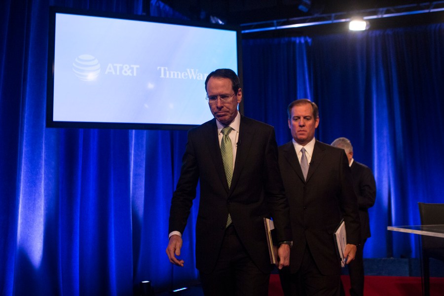 AT&T Chairman and CEO Randall Stephenson and AT&T Senior Executive Vice President David R. McAtee II leave after a news conference in Time Warner headquarters addressing the latest developments in the AT&T and Time Warner merger on Nov. 20, 2017 in New York City. (Credit: Amir Levy/Getty Images)