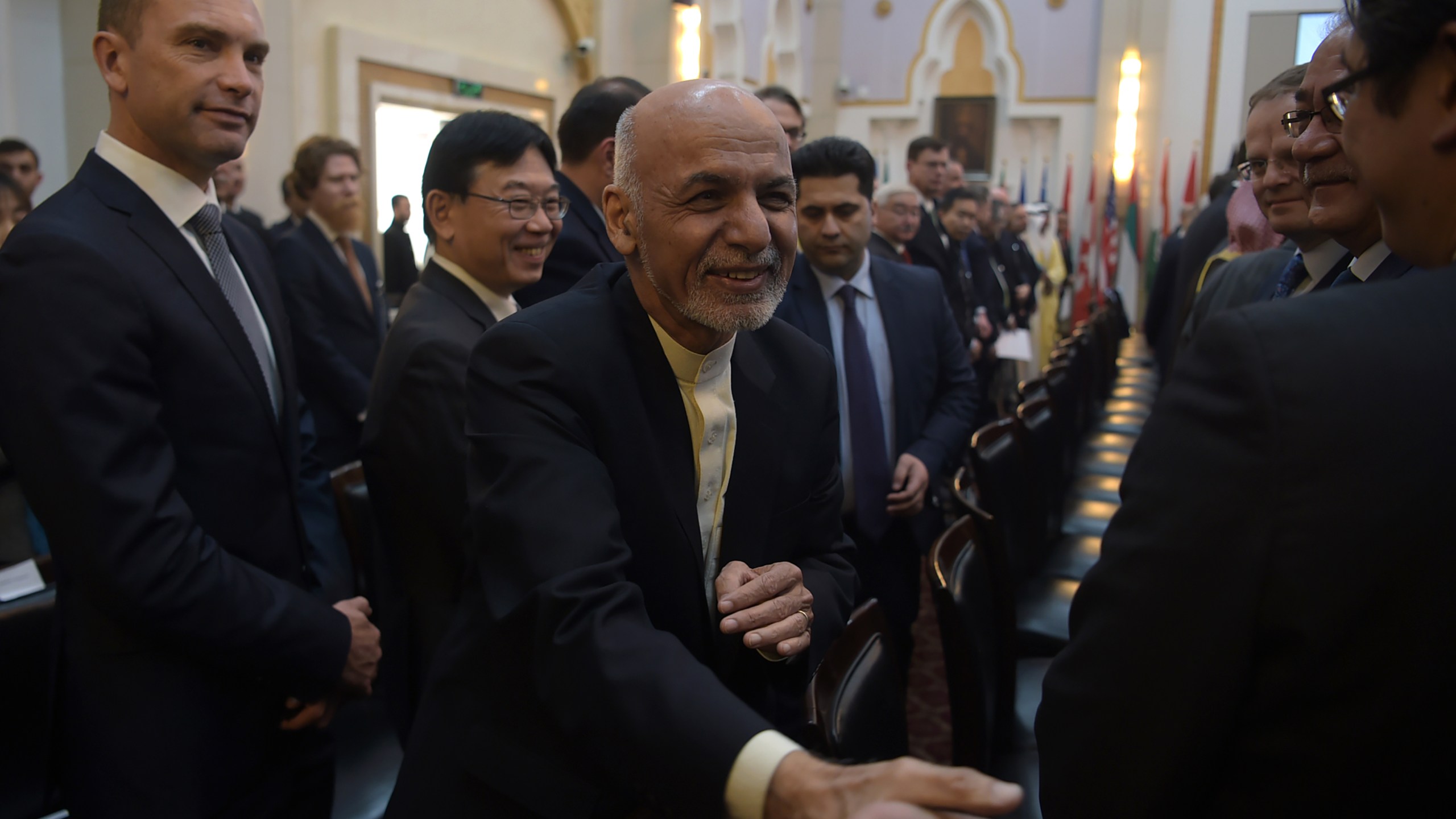 Afghan President Ashraf Ghani shakes hands with a foreign delegate at the second Kabul Process conference at the Presidential Palace in Kabul on February 28, 2018. (Credit: Shah Marai ARAI/AFP/Getty Images)