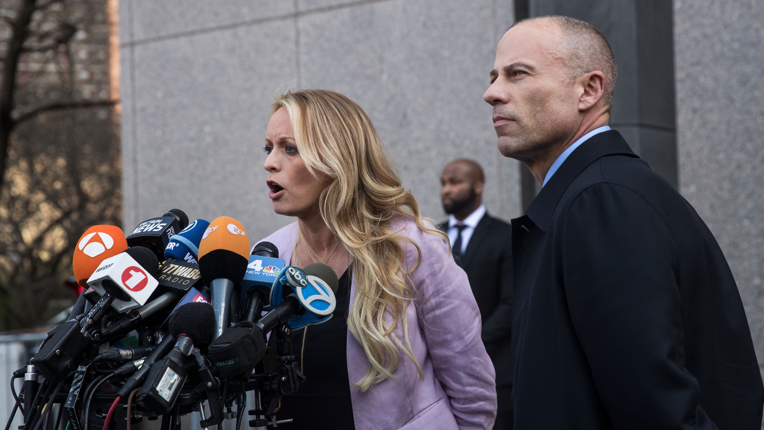 Adult film actress Stormy Daniels, whose legal name is Stephanie Clifford, and Michael Avenatti, her attorney, speak to the media as they exit the United States District Court Southern District of New York for a hearing related to Michael Cohen, President Trump's longtime personal attorney and confidante, on April 16, 2018, in New York City. (Credit: Drew Angerer/Getty Images)