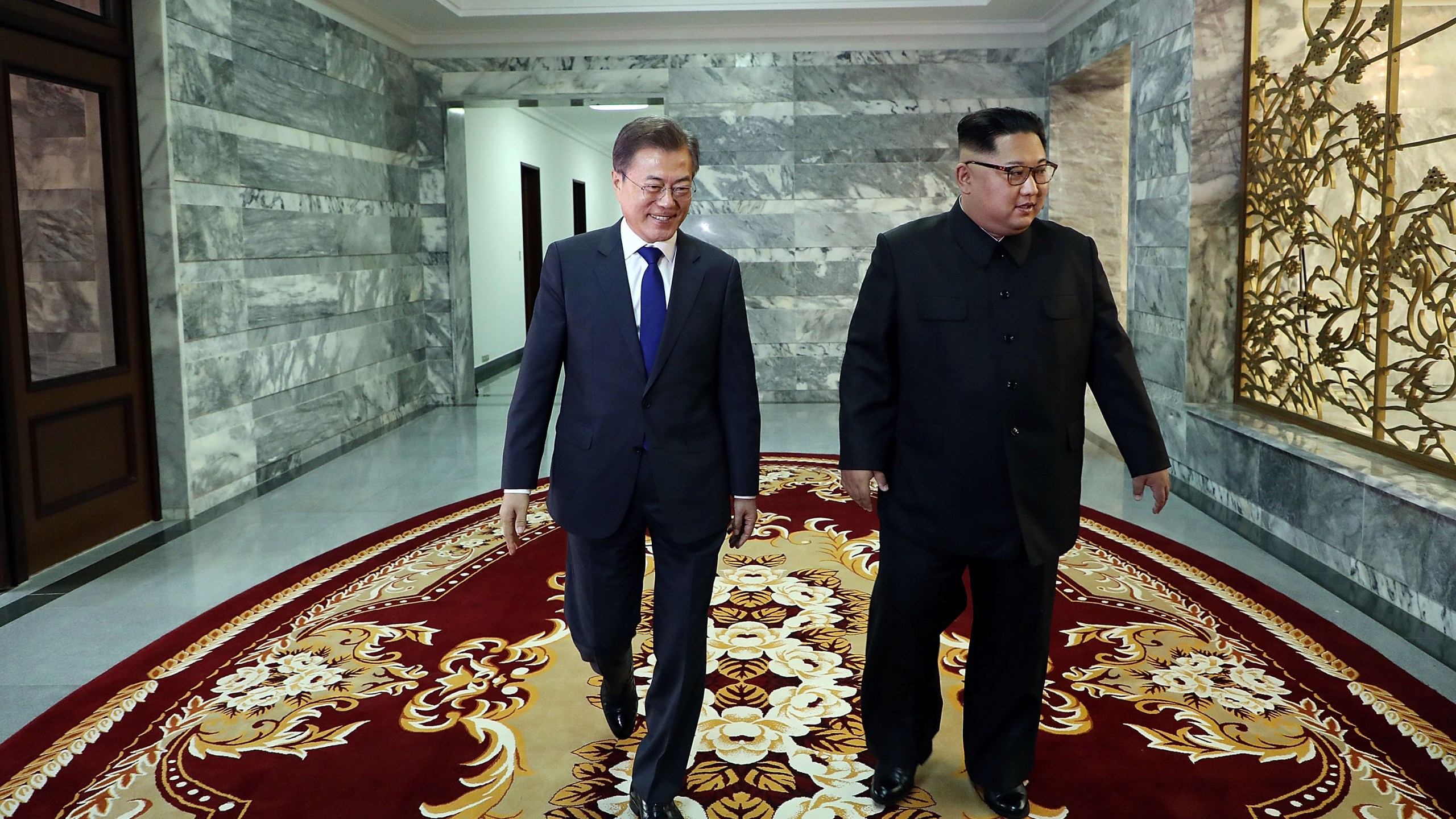 In this handout image provided by South Korean Presidential Blue House, South Korean President Moon Jae-in (left) walks with North Korean leader Kim Jong-un (right) during their meeting on May 26, 2018 in Panmunjom, North Korea. (Credit: South Korean Presidential Blue House via Getty Images)