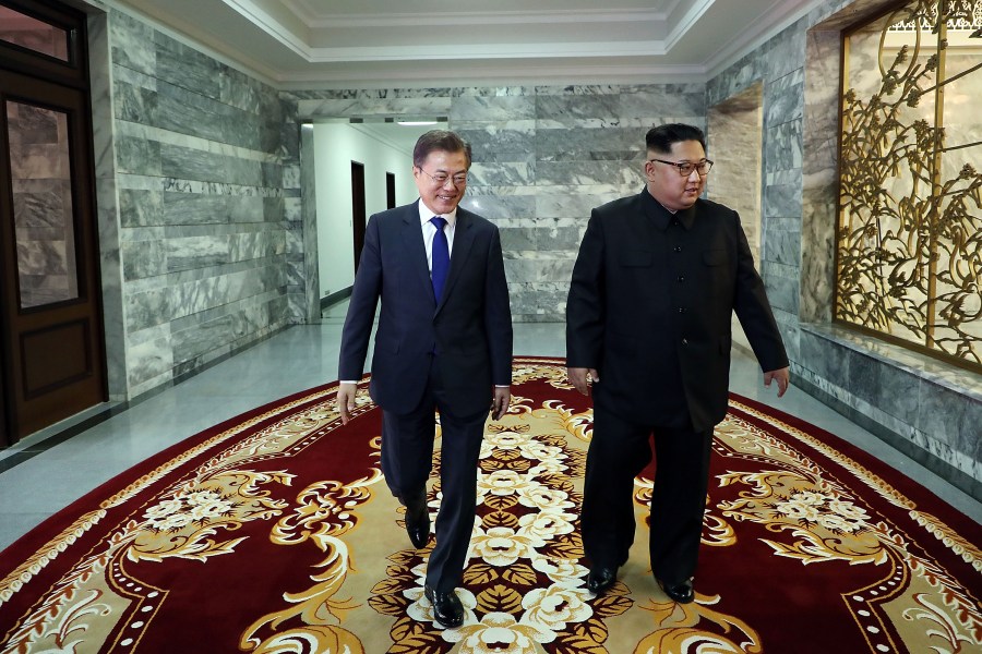 In this handout image provided by South Korean Presidential Blue House, South Korean President Moon Jae-in (left) walks with North Korean leader Kim Jong-un (right) during their meeting on May 26, 2018 in Panmunjom, North Korea. (Credit: South Korean Presidential Blue House via Getty Images)