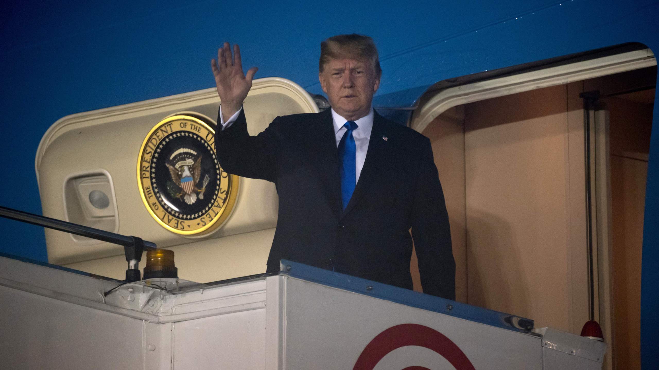 Donald Trump waves after Air Force One arrived at Paya Lebar Air Base in Singapore on June 10, 2018. (Credit: SAUL LOEB/AFP/Getty Images)