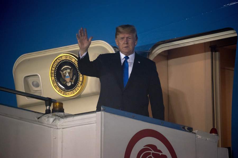 Donald Trump waves after Air Force One arrived at Paya Lebar Air Base in Singapore on June 10, 2018. (Credit: SAUL LOEB/AFP/Getty Images)