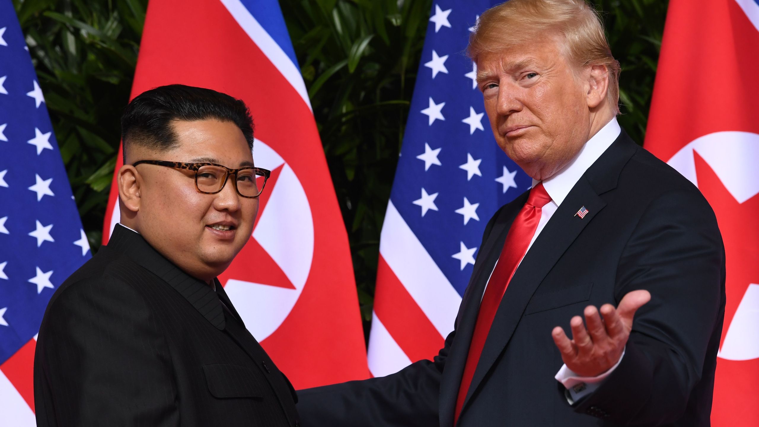 President Donald Trump gestures as he meets with North Korea's leader Kim Jong Un at the start of their historic summit in Singapore on June 12, 2018. (Credit: Saul Loeb / AFP / Getty Images)