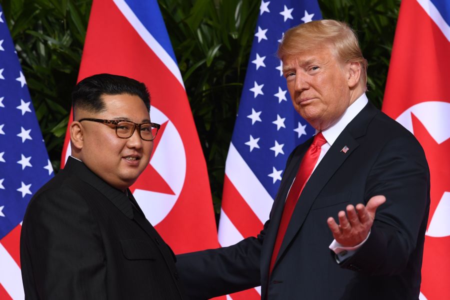 President Donald Trump gestures as he meets with North Korea's leader Kim Jong Un at the start of their historic summit in Singapore on June 12, 2018. (Credit: Saul Loeb / AFP / Getty Images)