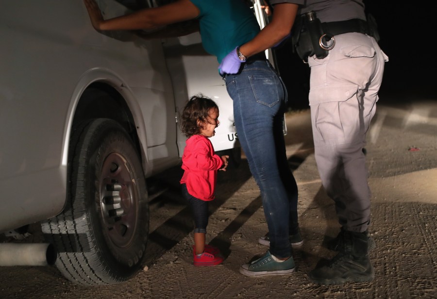 A 2-year-old Honduran asylum seeker cries as her mother is searched and detained near the U.S.-Mexico border on June 12, 2018, in McAllen, Texas. (Credit: John Moore / Getty Images)