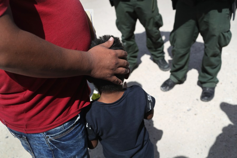 U.S. Border Patrol agents take a father and son from Honduras into custody near the U.S.-Mexico border on June 12, 2018 near Mission, Texas. (Credit: John Moore/Getty Images)