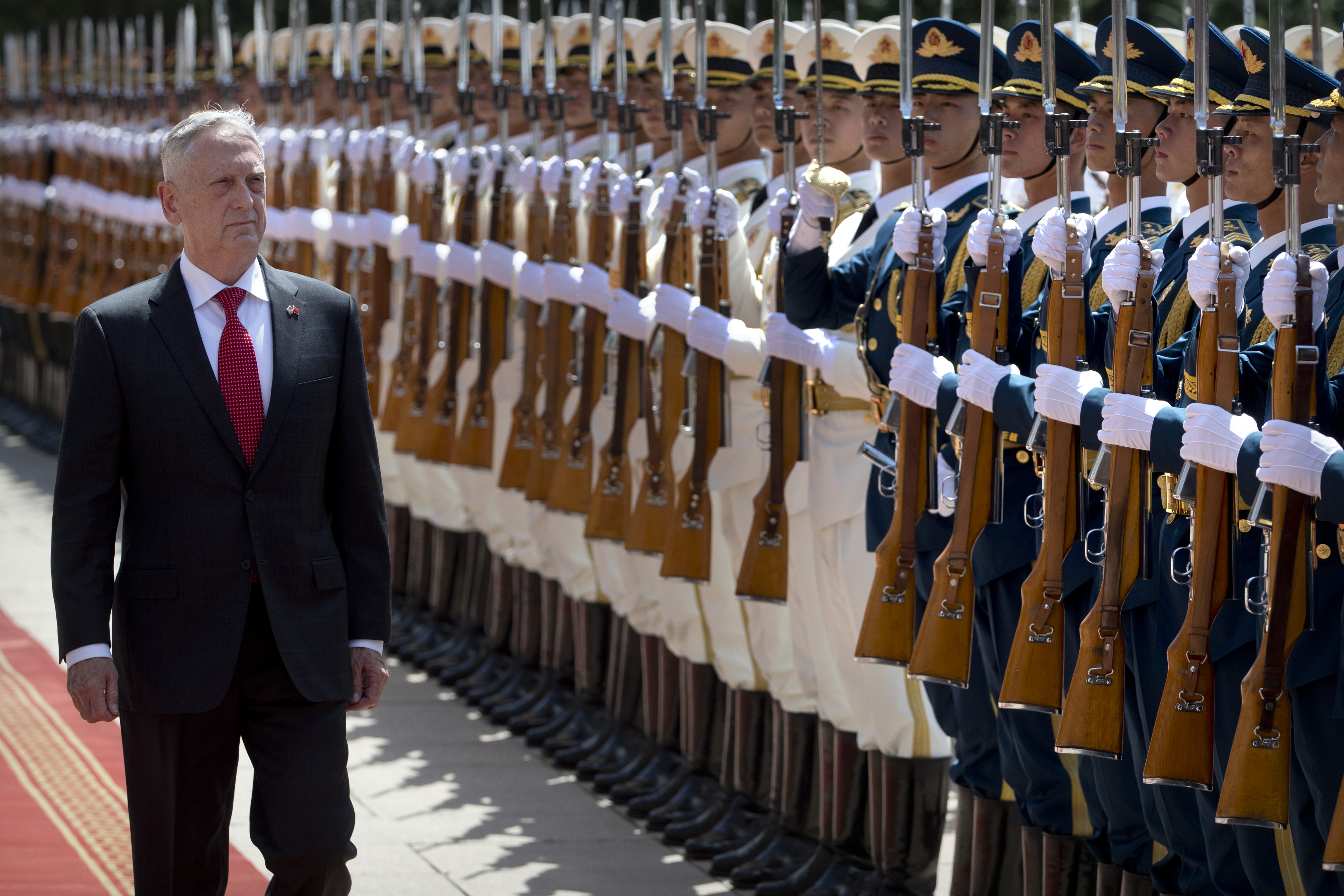 U.S. Defense Secretary Jim Mattis, left, inspects and honour guard during a welcome ceremony at the Bayi Building in Beijing on June 27, 2018. (Credit: Mark Schiefelbein/AFP/Getty Images)