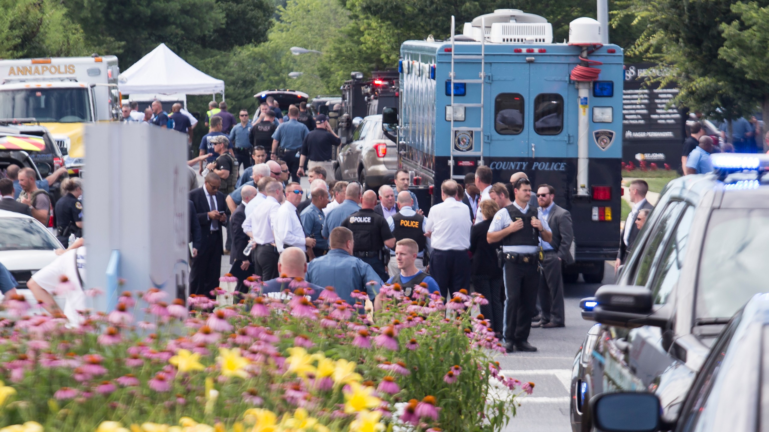 Emergency personnel congregate outside the Capital Gazette newspaper building on June 28, 2018 in Annapolis, Maryland. Five people were killed when a gunman opened fire in the newsroom. (Credit: Alex Wroblewski/Getty Images)