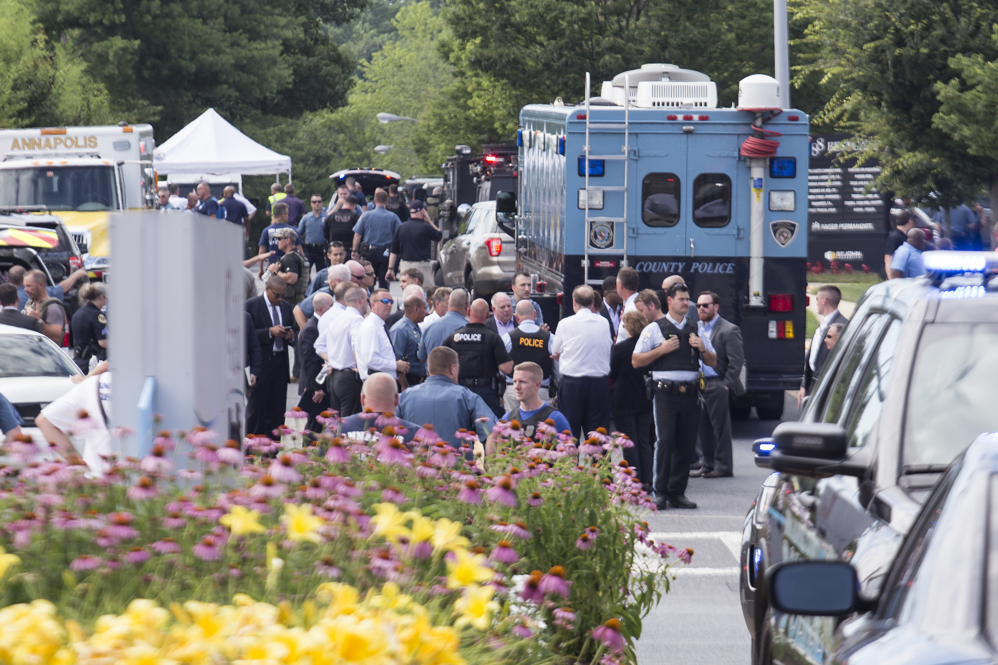 Emergency personnel congregate outside the Capital Gazette newspaper building on June 28, 2018 in Annapolis, Maryland. Five people were killed when a gunman opened fire in the newsroom. (Credit: Alex Wroblewski/Getty Images)