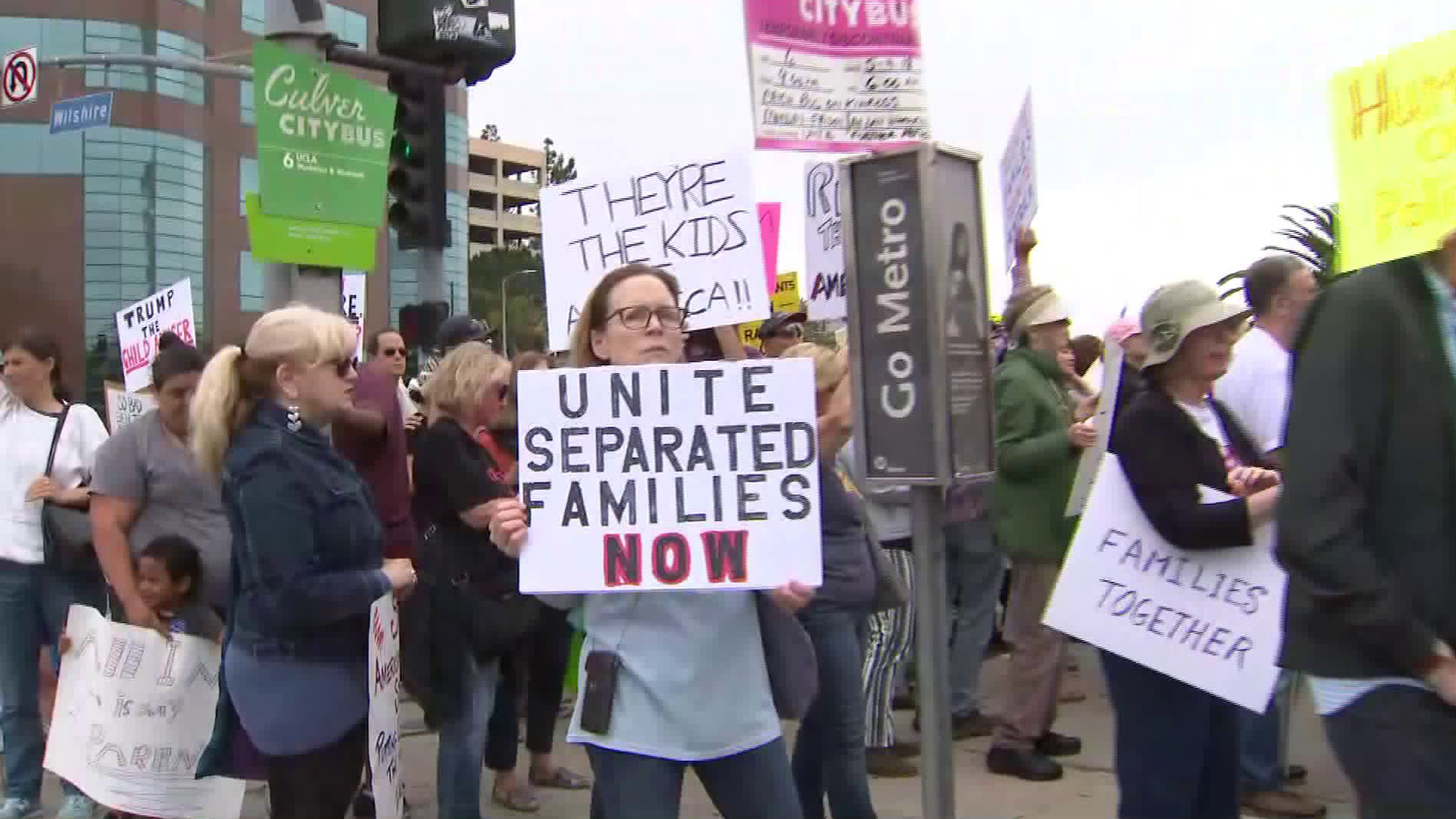 Community members gather in Westwood on June 23, 2018, to rally in support of children separated from their parents at the border. (Credit: KTLA)