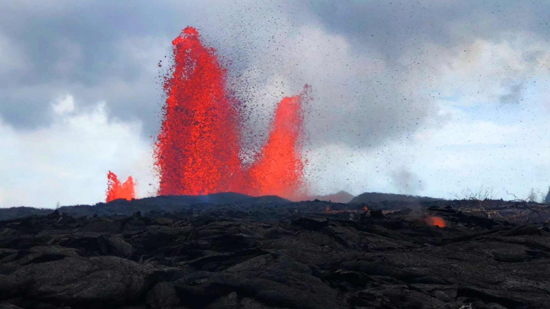 Lava from Hawaii’s Kilauea volcano is seen shooting into the air in this undated photo. (Credit: USGS via CNN)