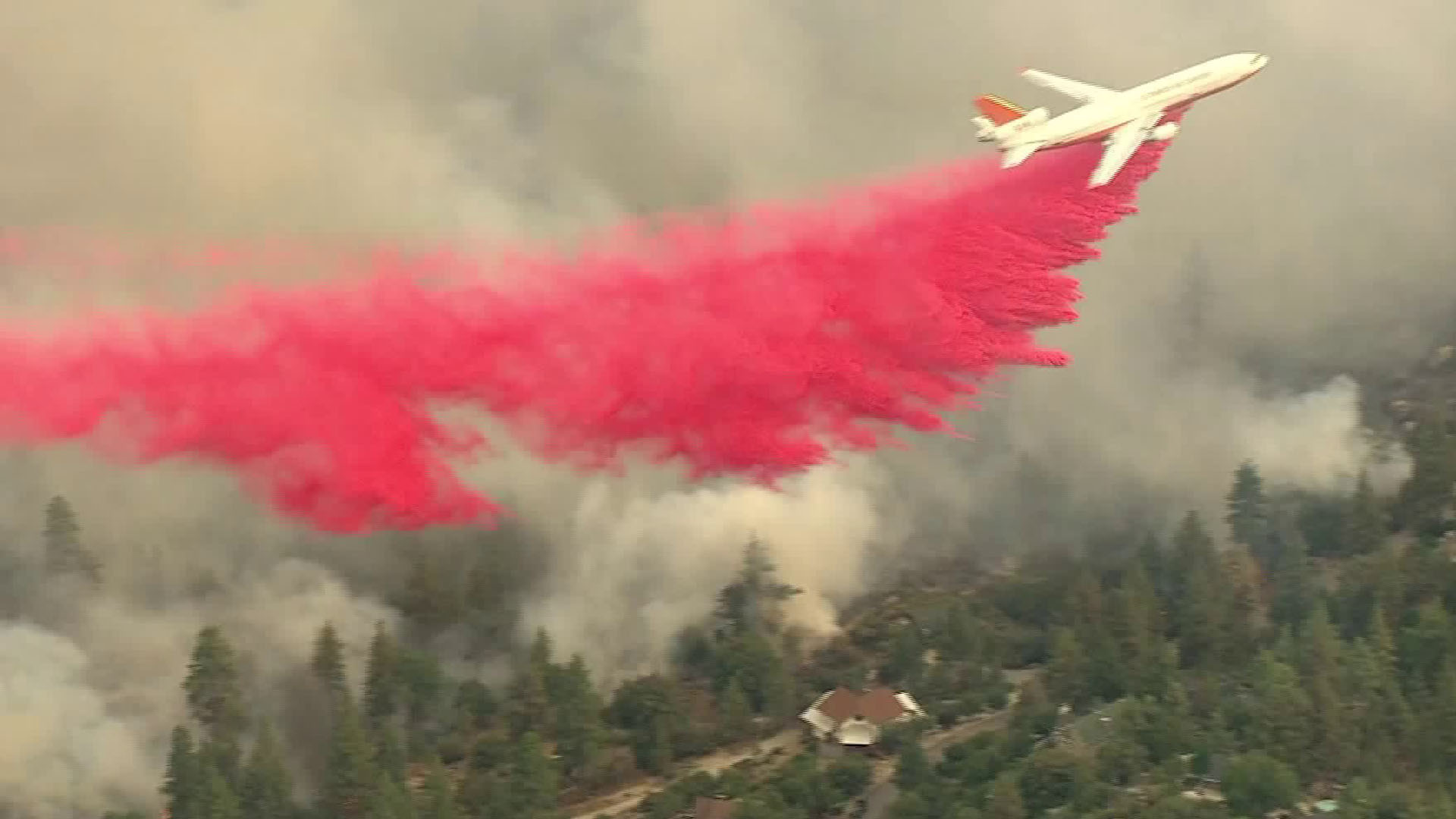 An aircraft makes a fire retardant drop as the Cranston Fire burns in Idyllwild on July 25, 2018. (Credit: KTLA)