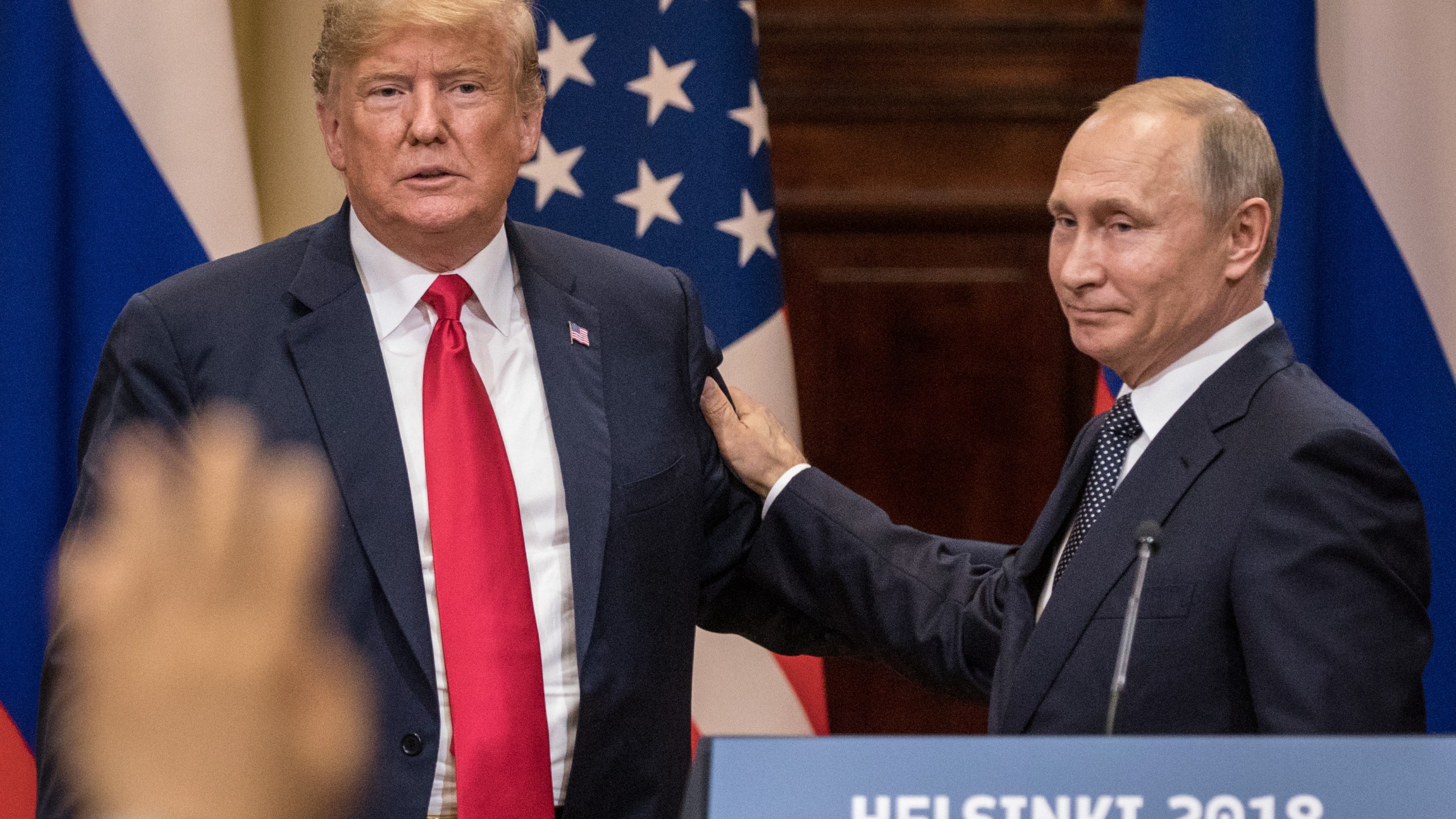 U.S. President Donald Trump, left, and Russian President Vladimir Putin shake hands during a joint press conference after their summit on July 16, 2018, in Helsinki, Finland. (Credit: Chris McGrath/Getty Images)