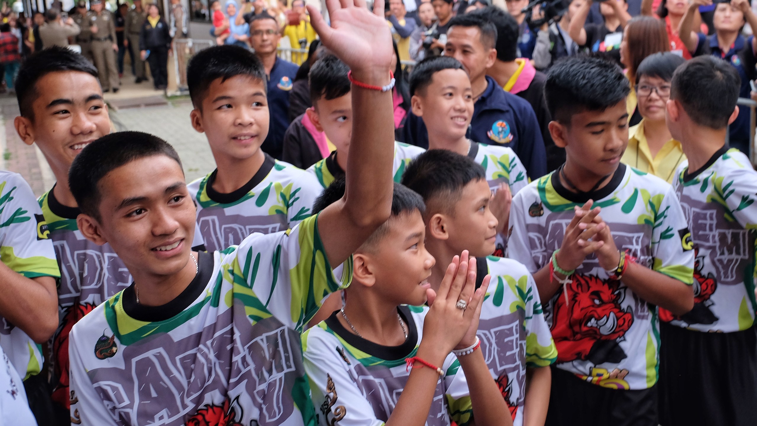 Twelve boys and their coach from the 'Wild Boars' soccer team arrive for a press conference for the first time since they were rescued from a cave in northern Thailand last week, on July 18, 2018 in Chiang Rai, Thailand. (Credit: Linh Pham/Getty Images)