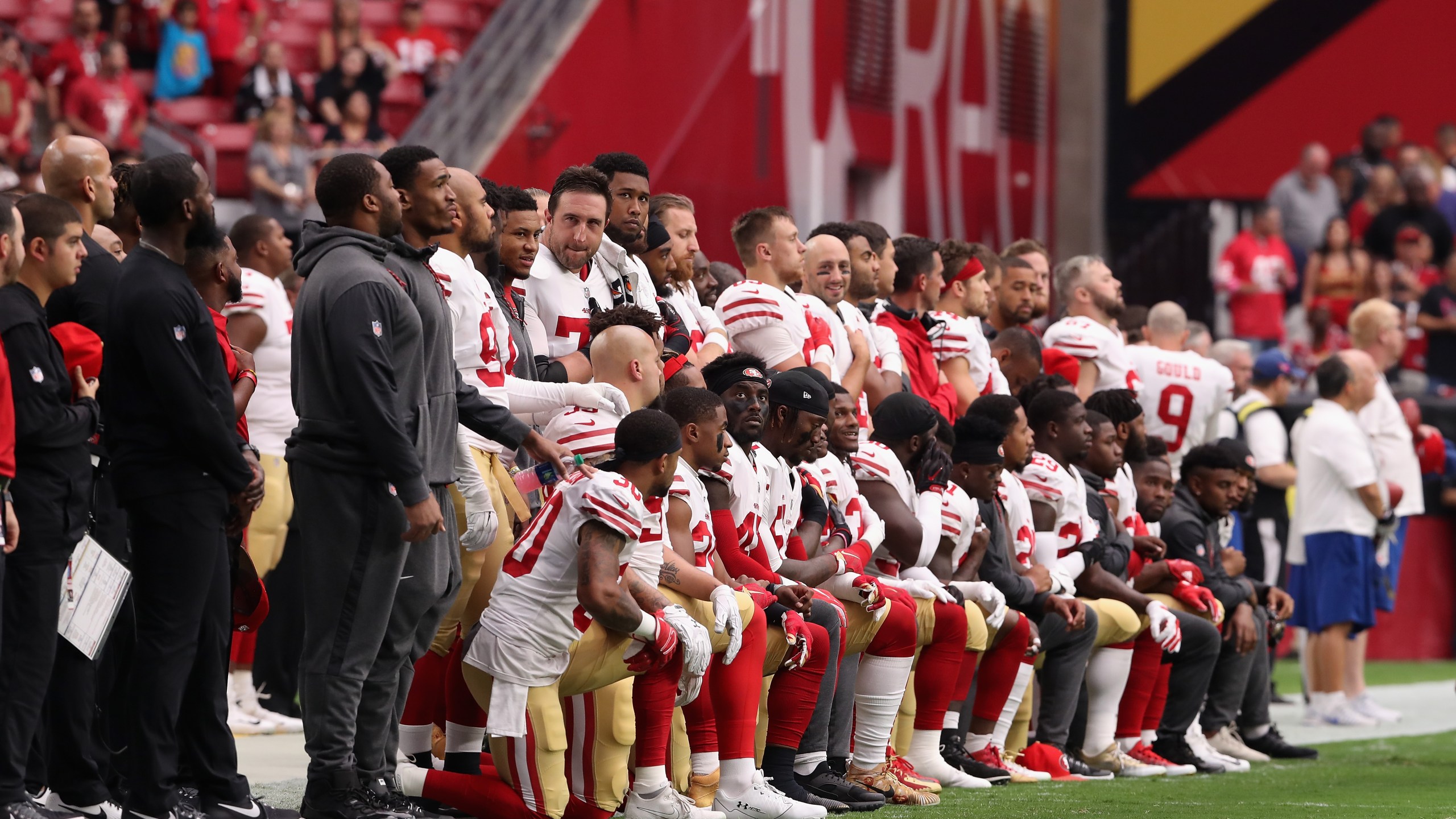 Members of the San Francisco 49ers kneel for the National Anthem before the start of the NFL game against the Arizona Cardinals at the University of Phoenix Stadium on Oct. 1, 2017 in Glendale, Arizona. (Credit: Christian Petersen/Getty Images)