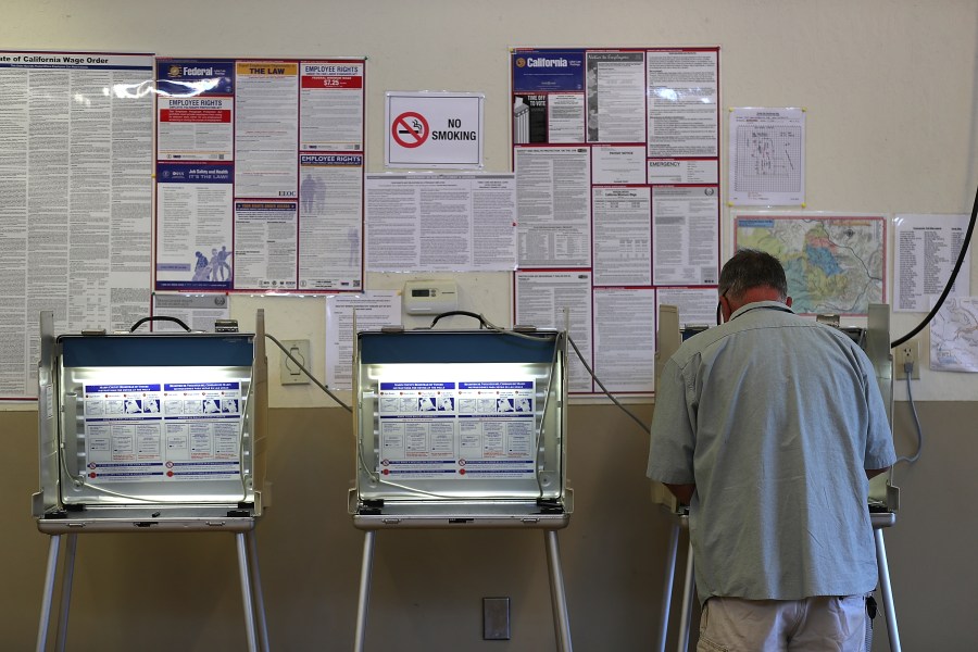 A voter fills out a ballot inside a polling station at a Ross Valley fire station in San Anselmo on June 5, 2018. (Credit: Justin Sullivan / Getty Images)