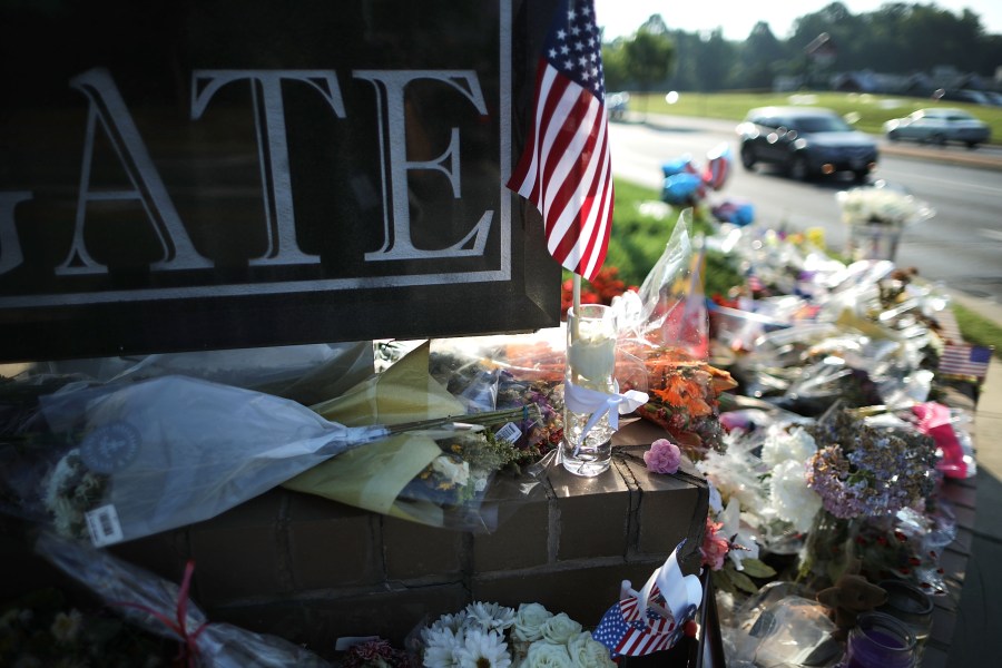 Flowers, flags and hand-written notes are gathered in a makeshift memorial outside the Capitol Gazette offices in Annapolis, Maryland, on July 2, 2018, for the employees killed by a gunman the week before. (Credit: Chip Somodevilla / Getty Images)