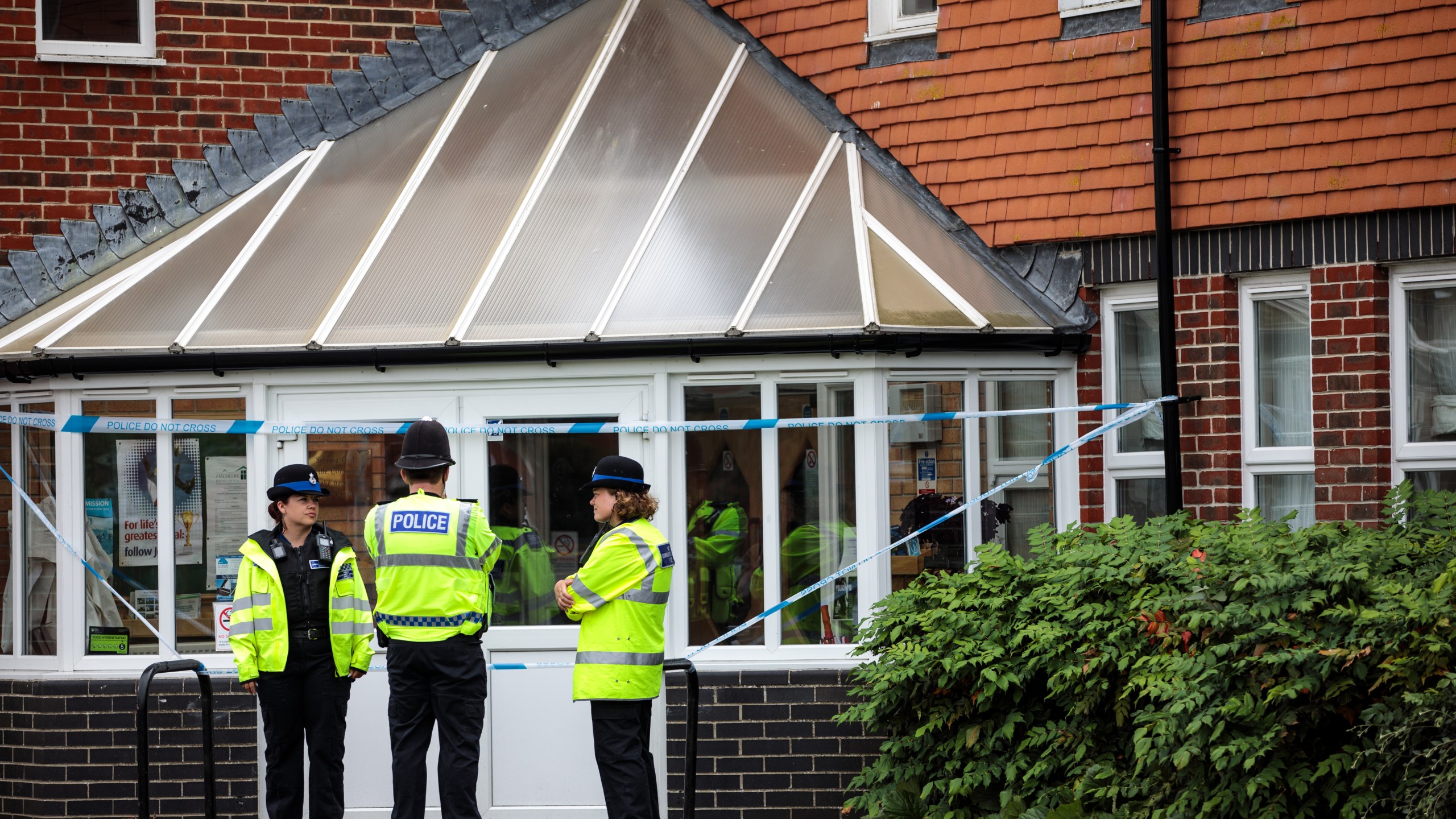 Officials convene at the scene outside Amesbury Baptist Centre as Wiltshire Police declare a major incident after a man and woman were exposed to an unknown substance on July 4, 2018, in Amesbury, England. (Credit: Jack Taylor / Getty Images)