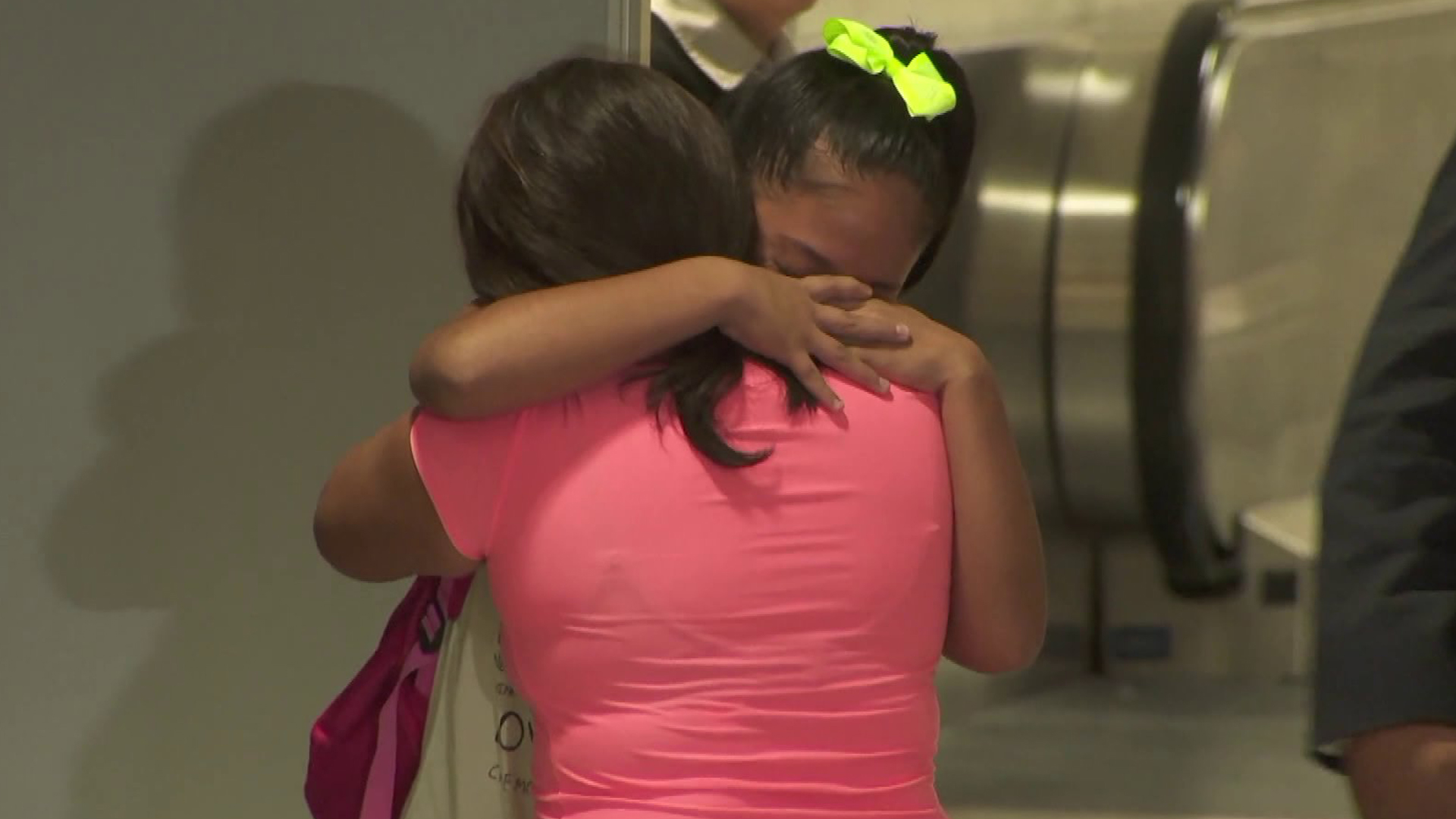 Perla De Velasquez hugs her 12-year-old daughter, Yoselin, tightly as the two are reunited at LAX on July 1, 2018, after more than a month apart. They had been separated by federal immigration authorities. (Credit KTLA)