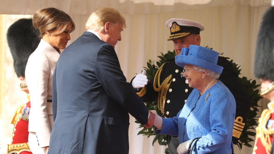 Britain's Queen Elizabeth II shakes hands with Donald Trump as he and US First Lady Melania Trump arrive for a welcome ceremony at Windsor Castle on July 13, 2018. (Credit: Chris Jackson / POOL / Getty Images)