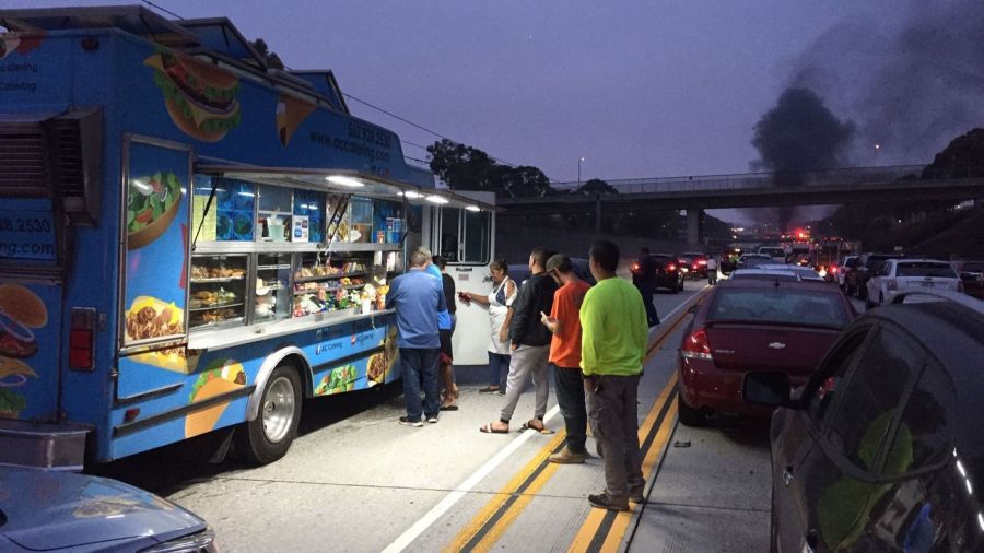 Commuters form a line to buy snacks after a double fatal fiery crash shut down the 105 Freeway in Hawthorne on Aug. 24, 2018. (Credit: Chris Keller / Los Angeles Times)