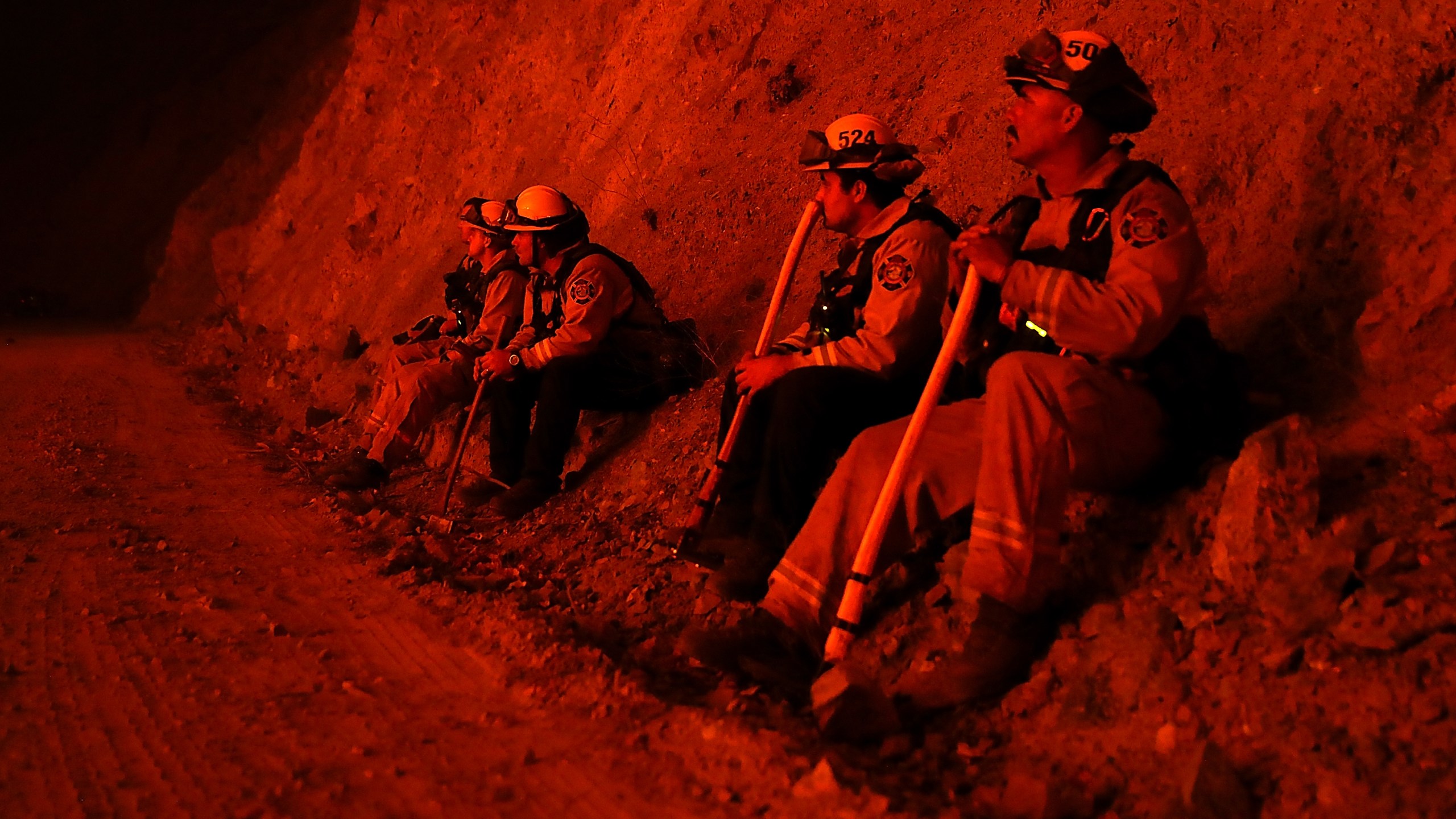 Firefighters monitor a back fire as they battle the Medocino Complex fire on Aug. 7, 2018, near Lodoga. (Credit: Justin Sullivan / Getty Images)