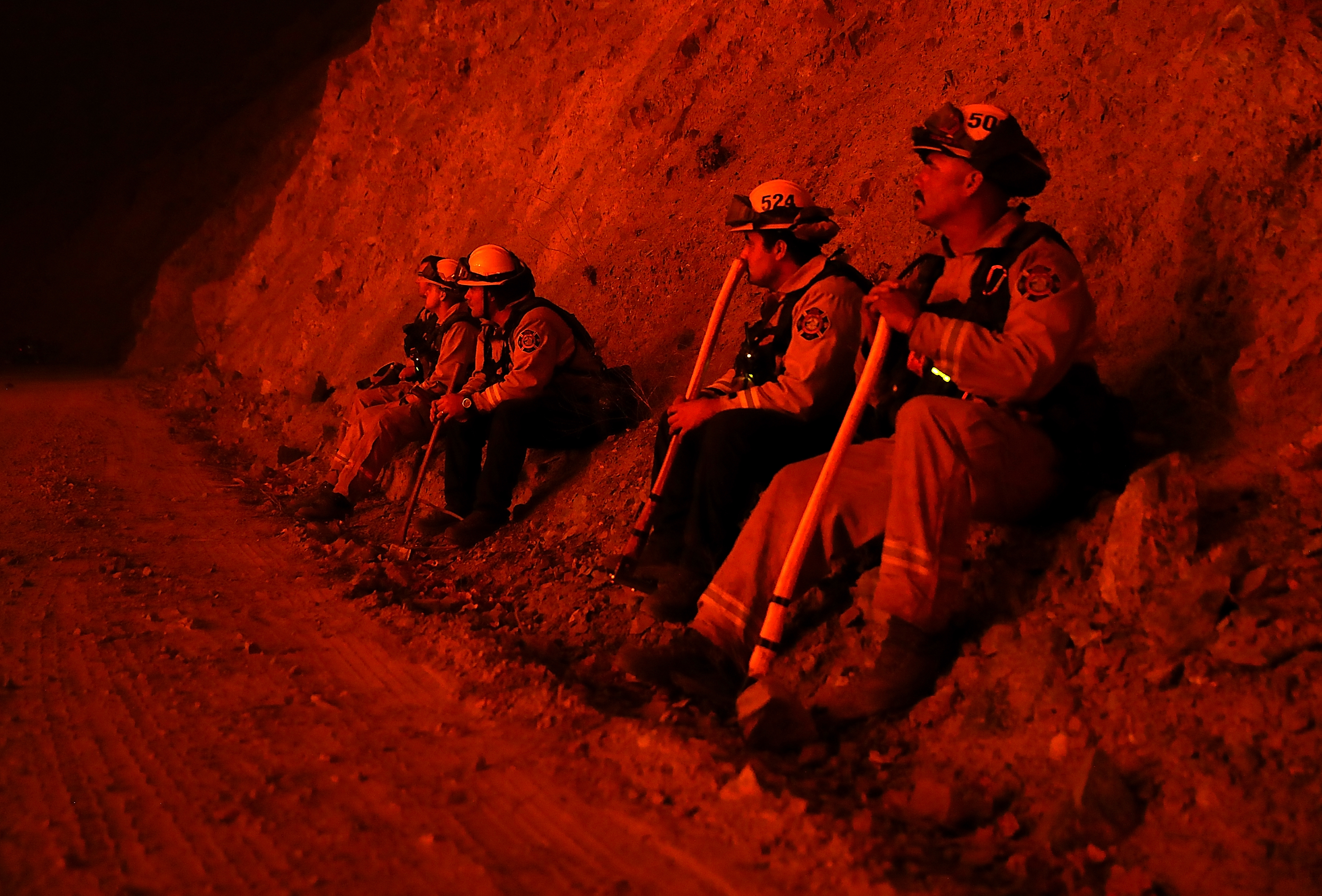 Firefighters monitor a back fire as they battle the Medocino Complex fire on Aug. 7, 2018, near Lodoga. (Credit: Justin Sullivan / Getty Images)