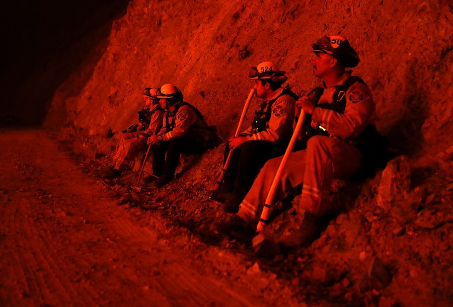 Firefighters monitor a back fire as they battle the Medocino Complex fire on Aug. 7, 2018, near Lodoga. (Credit: Justin Sullivan / Getty Images)