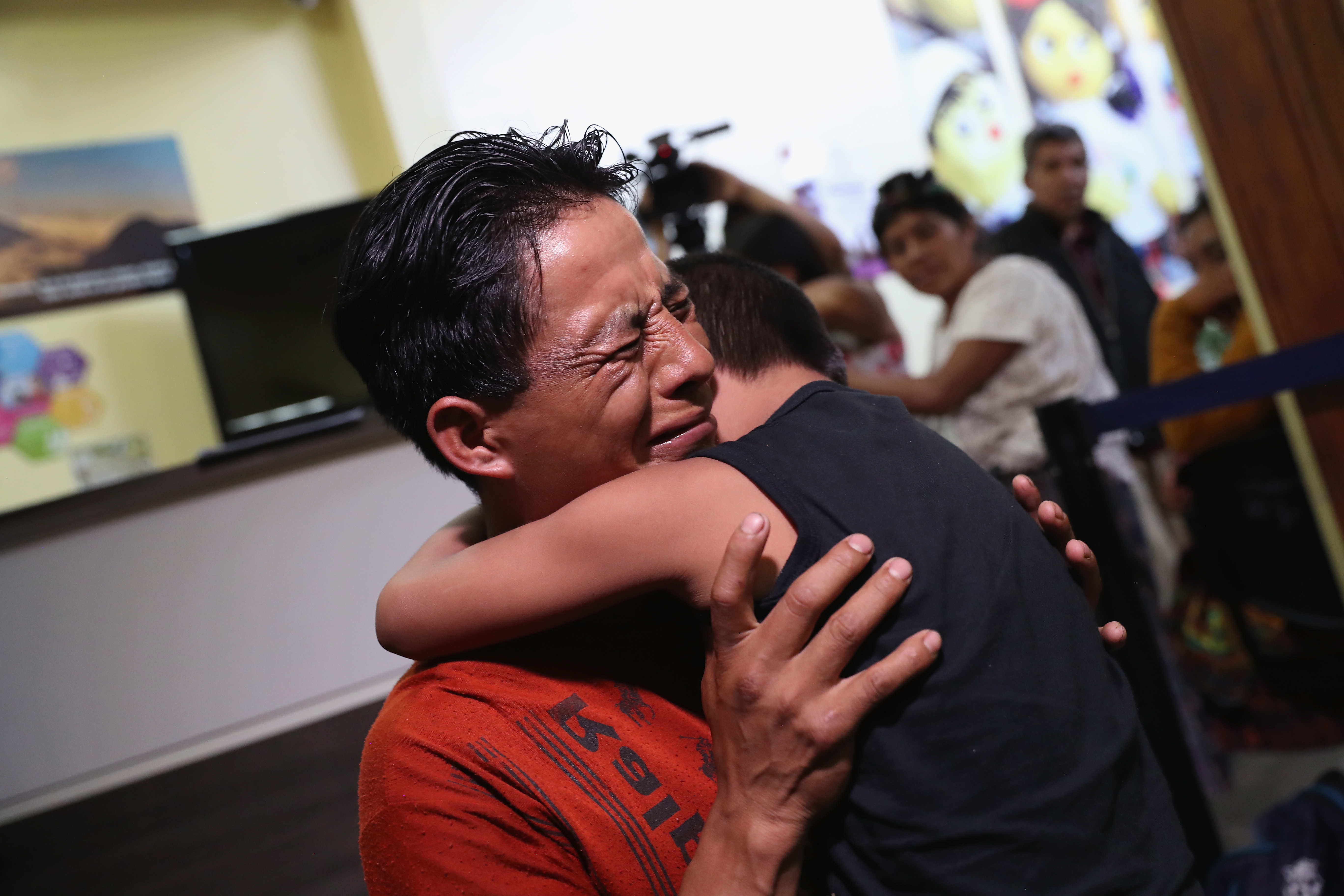 An emotional father embraces his son for the first time in months on Aug. 7, 2018, in Guatemala City, Guatemala. (Credit: John Moore / Getty Images)