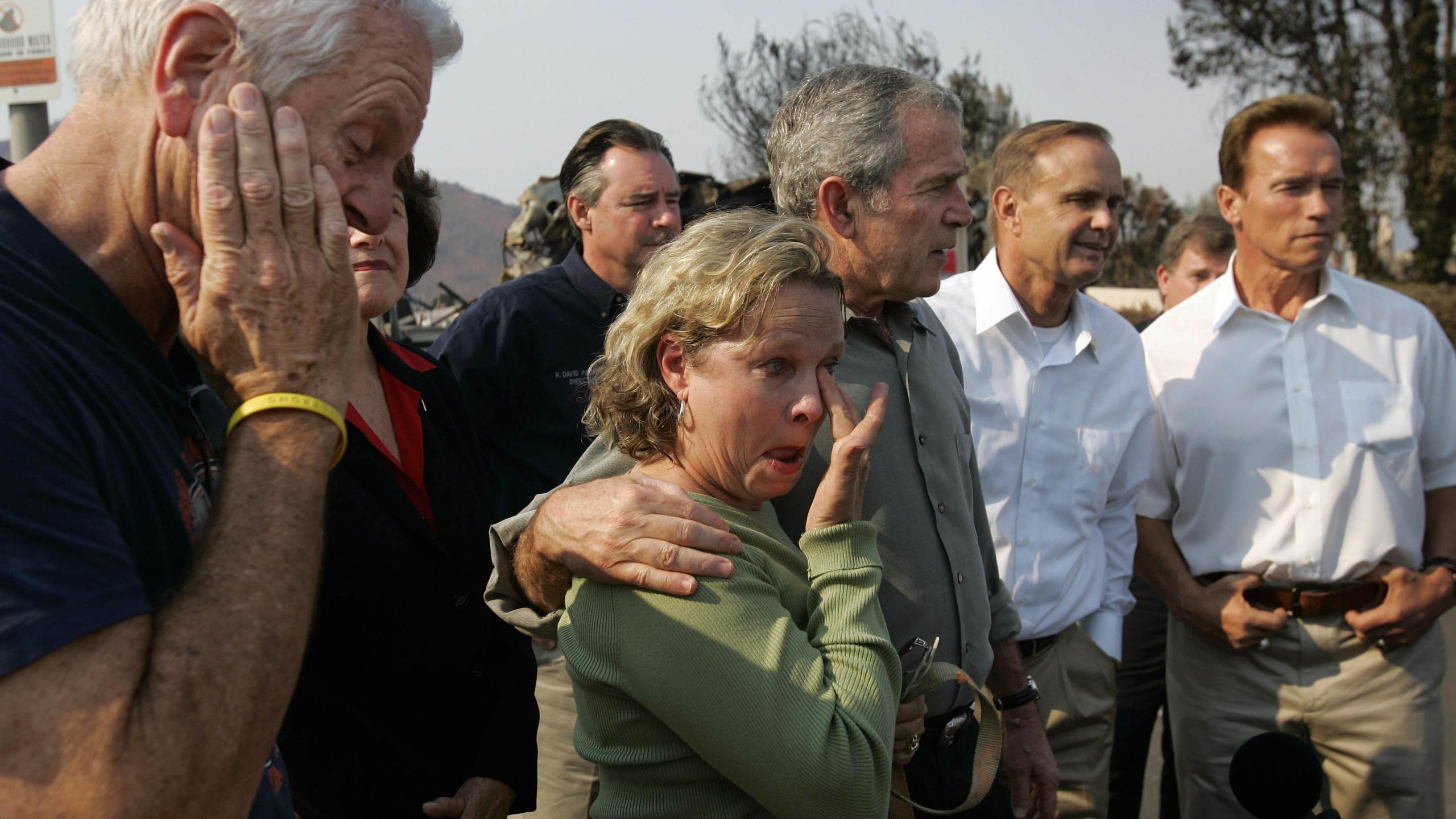 U.S. President George W. Bush and Congressman Brian Bilbray join Gov. Arnold Schwarzenegger in meeting with Jay and Kendra Jeffcoat, who lost their home in the recent wildfires in the Rancho Bernardo neighborhood of San Diego, on Oct. 25 2007. (Credit: K.C. Alfred/AFP/Getty Images)