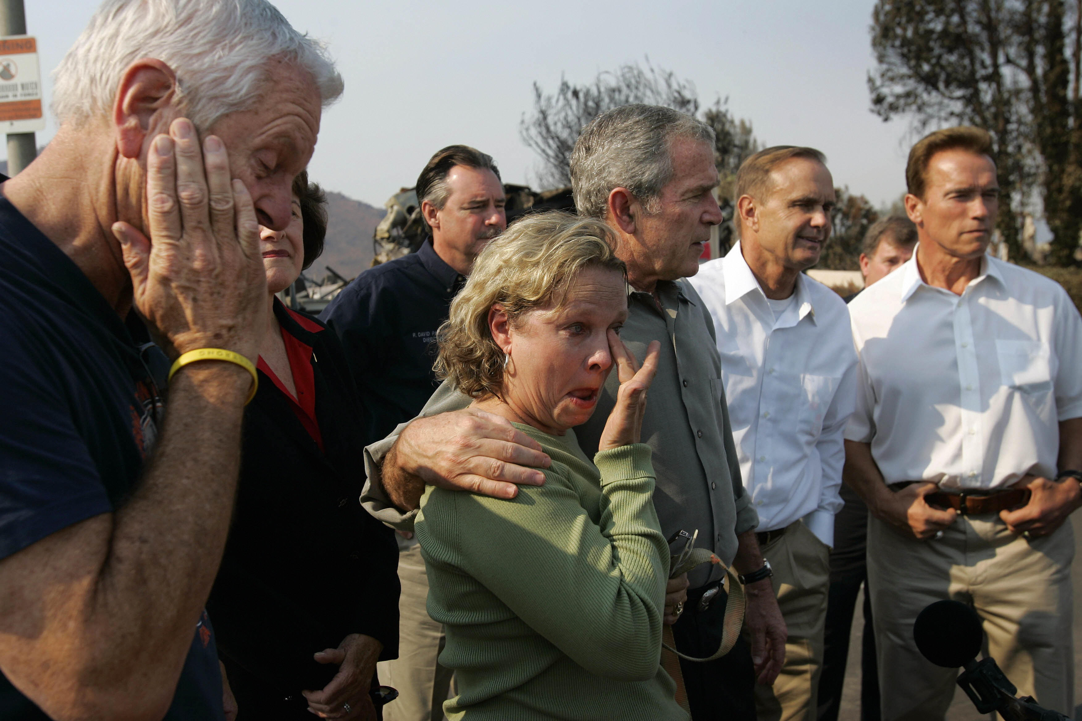 U.S. President George W. Bush and Congressman Brian Bilbray join Gov. Arnold Schwarzenegger in meeting with Jay and Kendra Jeffcoat, who lost their home in the recent wildfires in the Rancho Bernardo neighborhood of San Diego, on Oct. 25 2007. (Credit: K.C. Alfred/AFP/Getty Images)