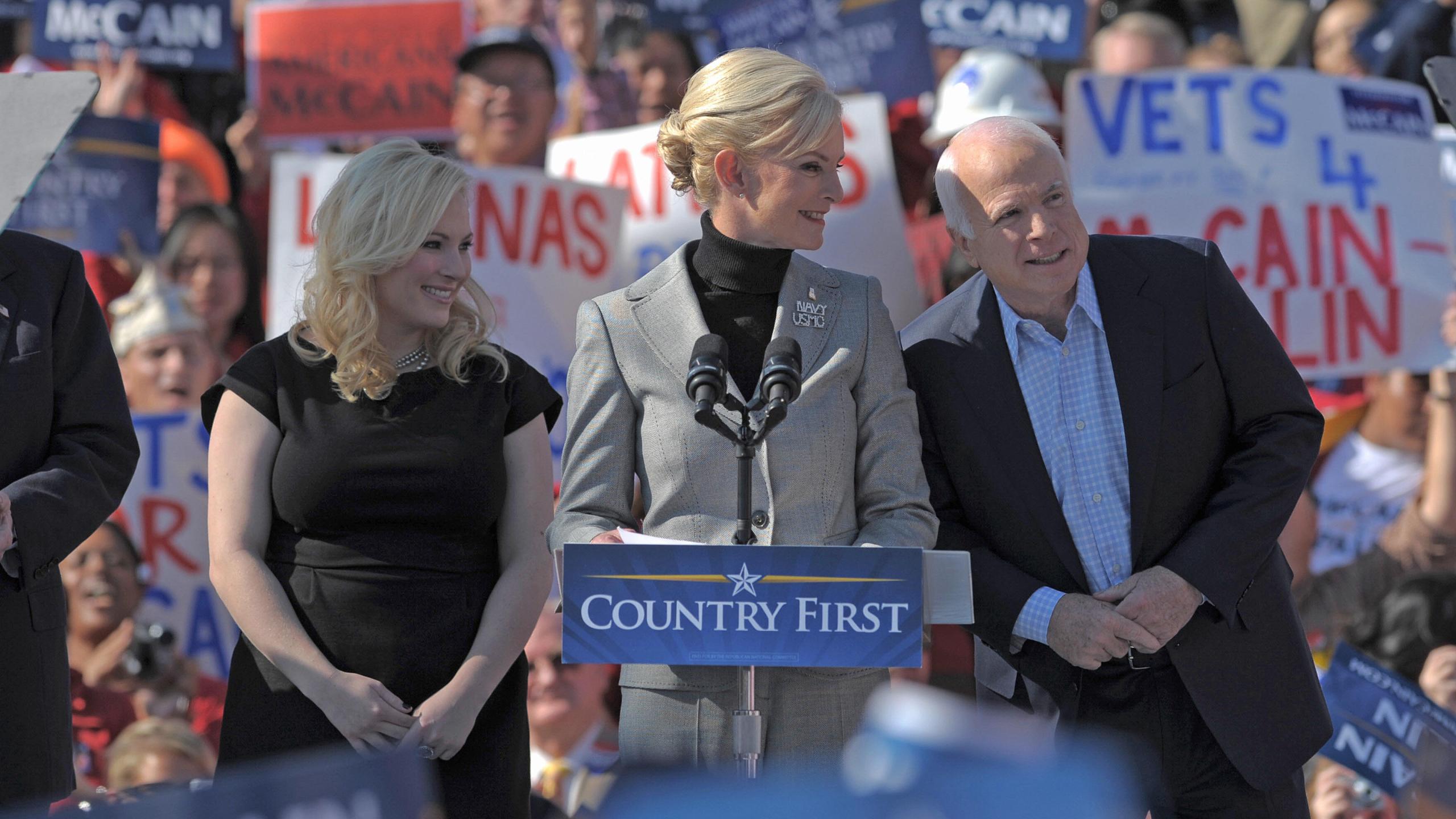 John McCain leans towards his wife Cindy as she speaks during a rally on Nov. 1, 2008 in Springfield, Virginia, with daughter Meghan. (Credit: MANDEL NGAN/AFP/Getty Images)