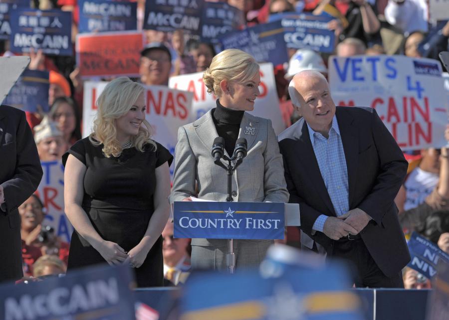 John McCain leans towards his wife Cindy as she speaks during a rally on Nov. 1, 2008 in Springfield, Virginia, with daughter Meghan. (Credit: MANDEL NGAN/AFP/Getty Images)