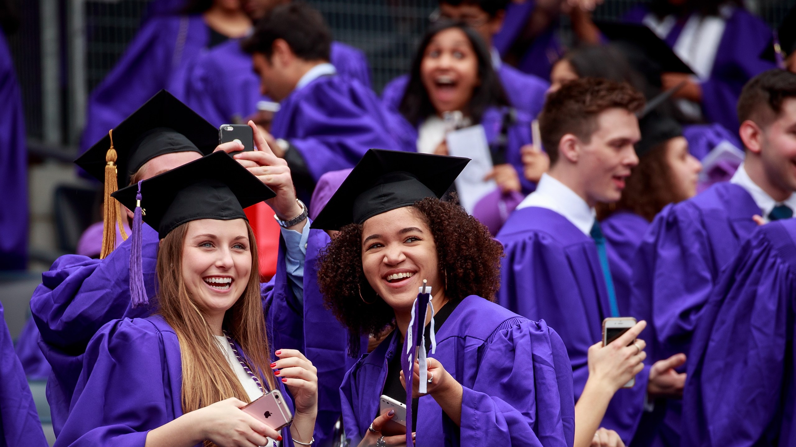 Graduating students wait for the start of New York University's commencement ceremony at Yankee Stadium, May 16, 2018, in the Bronx borough of New York City. (Credit: Drew Angerer/Getty Images)