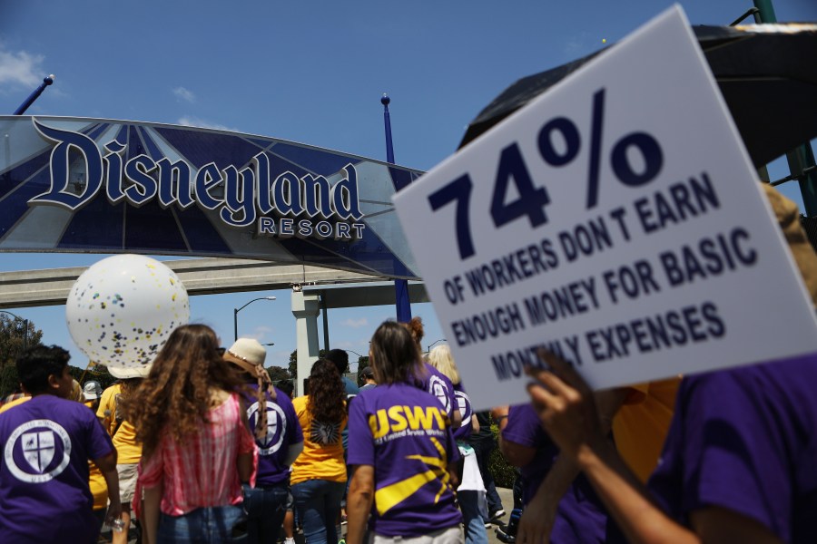 Protestors march at the Disneyland entrance on July 3, 2018 in Anaheim. (Credit: Mario Tama/Getty Images)