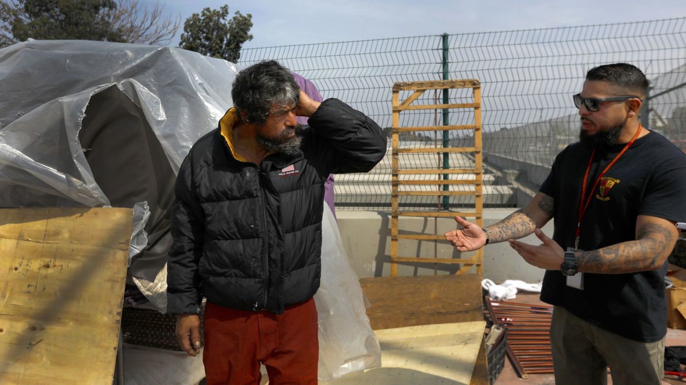 Adrian Tafoya, right, with the Homeless Outreach Program Integrated Care System talks to Jesus (no last name given) in Compton in an undated photo. (Credit: Francine Orr / Los Angeles Times)