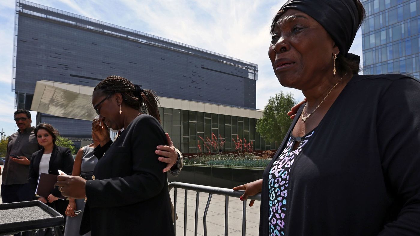 Heleine Tchayou, right, mother of Charly Leundeu Keunang, a homeless man shot and killed by LAPD on skid row, weeps as Keunang's sister Line Marquise Foming addresses a news conference about the family's lawsuit in 2016. (Credit: Irfan Khan / Los Angeles Times)