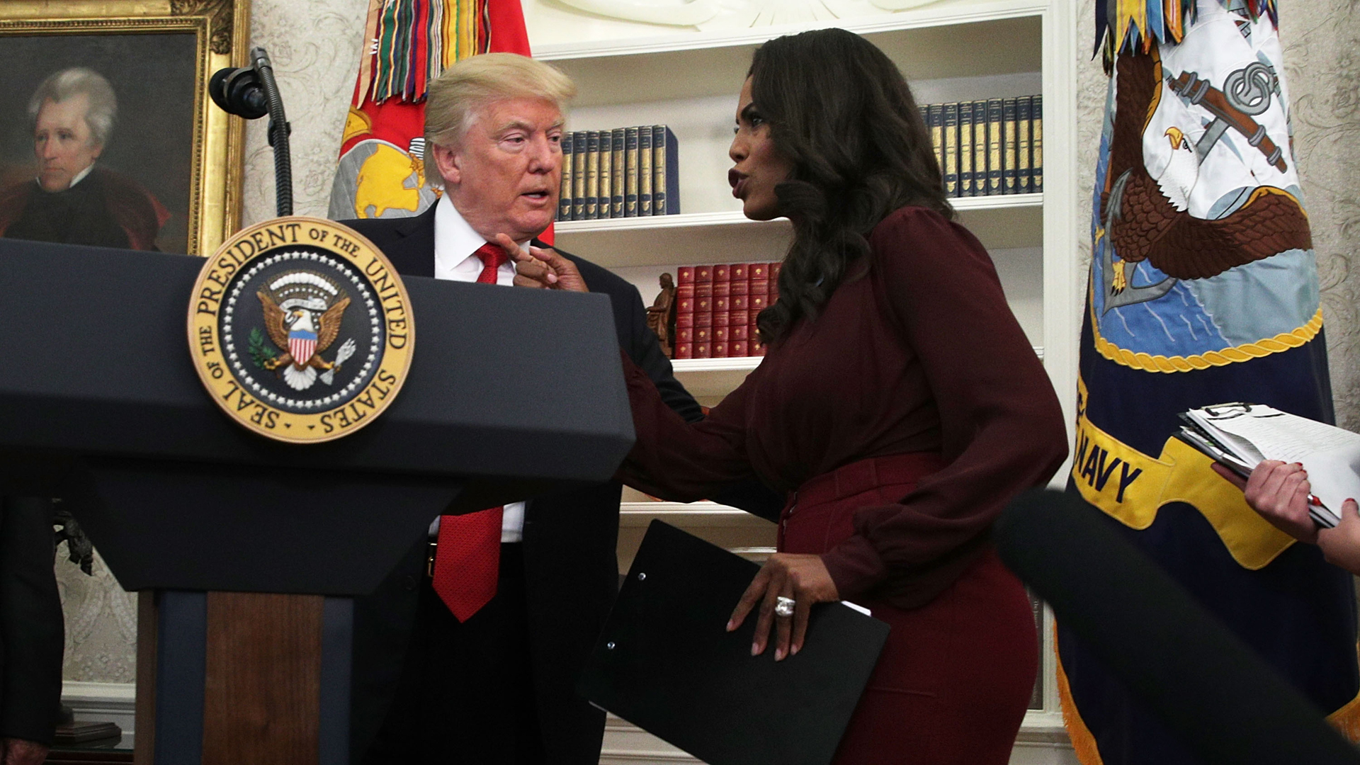 Donald Trump listens to Director of Communications for the White House Public Liaison Office Omarosa Manigault during an event in the Oval Office on Oct. 24, 2017. (Credit: Alex Wong/Getty Images)