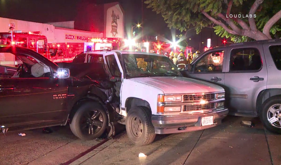 A car is seen pinned between two other vehicles in South Los Angeles on Aug. 26, 2018. (Credit: Loudlabs)