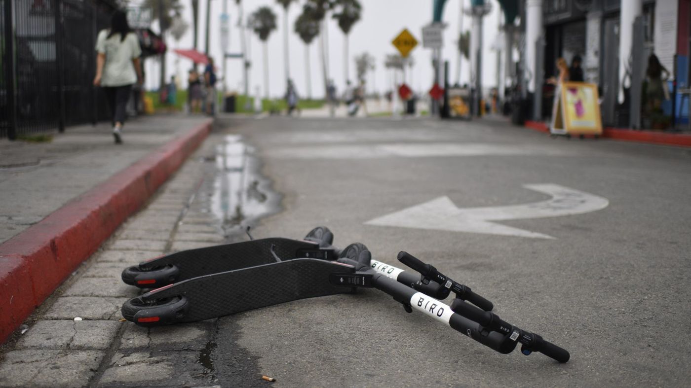 A pair of Bird scooters are seen on a street in Los Angeles in an undated photo. (Credit: Gabriel S. Scarlett / Los Angeles Times)