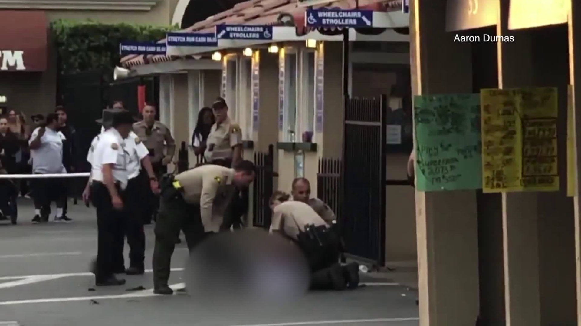 A man is seen on the ground at the Del Mar Fairgrounds after a deputy shot him after he allegedly opened fire on Sept. 3, 2018. (Credit: Aaron Dumas)