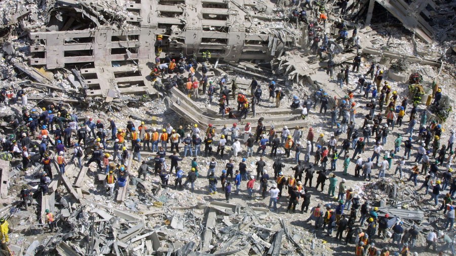 Rescue workers sift through the wreckage of the World Trade Center September 13, 2001 in New York City. (Credit: Mario Tama/Getty Images)